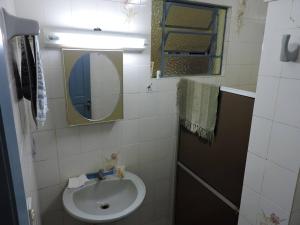 a small bathroom with a sink and a mirror at Pousada Sítio Paremi in Caxias do Sul +43 photos