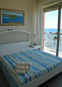 a bedroom with a bed with a view of the ocean at Taorminaxos wonderful seaview in Giardini Naxos