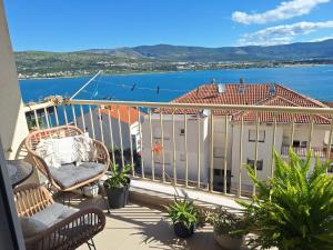 a balcony with chairs and a view of the water at Seaview apartman Vice in Trogir