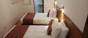 Rúm í herbergi á Saphi Inn Cusco - Excelente ubicación
