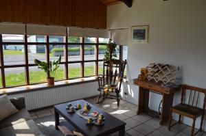 a living room with a table and a window at Túngata Guesthouse in Grenivík