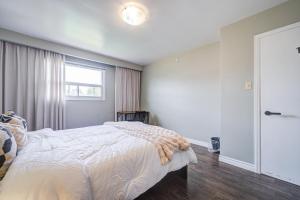 a bedroom with a bed and a window at Nest in the Orchard--cozy room in Toronto