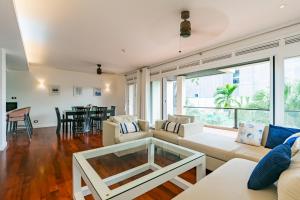 a living room with a couch and a table at 3BR Casa Azul - Beachfront Home in Laguna & Layan Chom Tawan and Maan Tawan Residences in Phuket Town