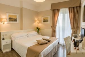 Postel nebo postele na pokoji v ubytování Hotel Modigliani
