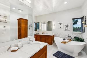 a bathroom with a large tub and a large mirror at New Skagit Tulip Farm Estate 3 beds 2 baths in Mount Vernon +42 photos