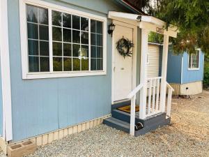 a blue house with a white door and a porch at Dafna, Unit 4 in Cromberg
