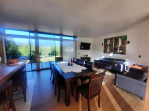 a living room with a table and a couch at Casa en San Andres Futrono in Futrono