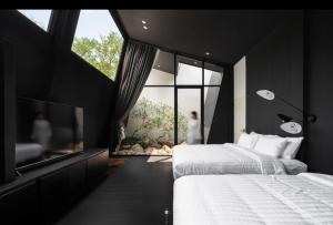 a bedroom with two beds and a large window at Hunter house in Ban Bung Toei +37 photos