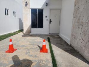 two orange cones in front of a building at Residencias crasky in Punta Cana