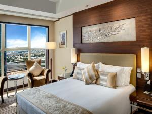 A bed or beds in a room at Grand Millennium Dubai
