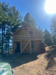 a log cabin in the middle of some trees at Aleos cabin in Kolgecaj