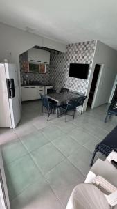 a kitchen and dining room with a table and chairs at Casa do Airton in Icapuí +4 photos
