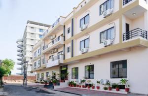 an apartment building with balconies and plants at The Park Classic Udaipur in Udaipur