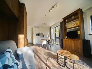a living room with a couch and a table at Apartment in Durbuy near Ourthe River in Durbuy
