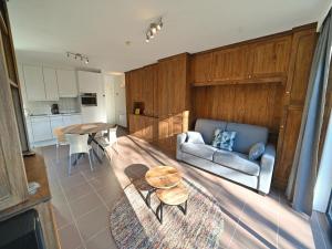 a living room with a couch and a table at Apartment in Durbuy near Ourthe River in Durbuy