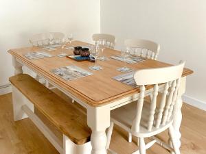 a dining room table with wine glasses on it at Snowdrop Cottage in Fishguard