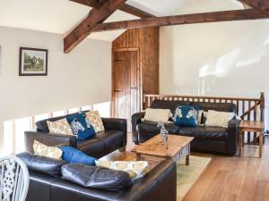 - un salon avec des canapés en cuir et une table basse dans l'établissement Mount Cottage-Uk42230, à Low Borrowbridge
