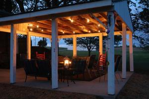 a pavilion with chairs and a table with a candle at The Hutch in Bardstown