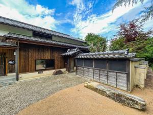 a house with a gate in front of it at Takeda Base Inn in Asago