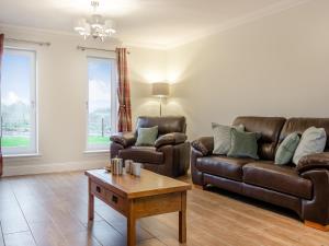 a living room with two leather couches and a coffee table at Iora Rua-Uk40006 in Gartmore +32 photos