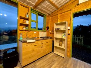 a kitchen with a refrigerator and a sink in a house at Cabaña Rustica Durango in Salento