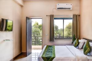 a bedroom with a bed and a window at The Park Classic Udaipur in Udaipur