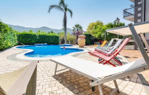 a patio with two chairs and a swimming pool at Nice Home In Giffoni Sei Casali in Giffoni Sei Casali