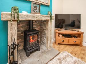 a fireplace in a living room with a stove at Rydal Cottage in Bowness-on-Windermere