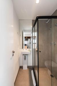 a bathroom with a glass shower and a sink at Kaza Noah VN Ueno Bela Vista in Sao Paulo +46 photos