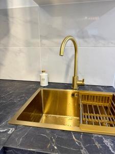 a kitchen counter with a sink and a faucet at O Refúgio dos Ferreiros in Guarda