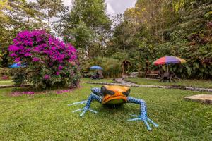 a statue of a crab sitting in the grass at Ecohotel Piedemonte in Salento