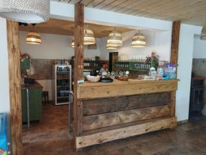 a shop with a wooden counter with pendant lights at Standa - Camp pod kaštany in Morávka