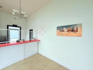 a room with a picture of horses on the wall at La Vista Motel in Brownsville