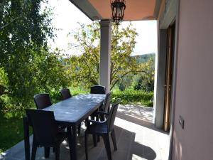 a black table and chairs on a patio with a window at Belvilla by OYO Paneolio in Pistoia