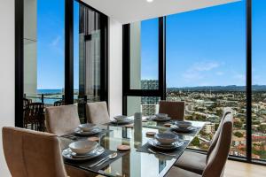 a dining room with a table and chairs with a view at Skyline Showdown - Views, Games & Vibes in Gold Coast