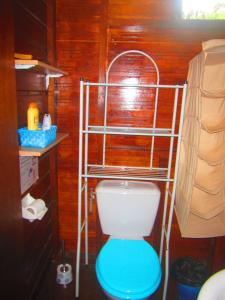 a bathroom with a toilet with a blue seat at Poétitude in Bourail +70 photos