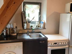 a small kitchen with a sink and a window at Maison de vigne charmante avec grande terrasse pour couple - FR-1-582-531 in Tailhac