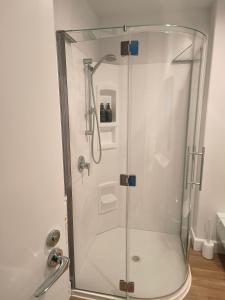 a shower with a glass door in a bathroom at 204 The Sands in Nelson +7 photos