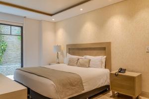 Voodi või voodid majutusasutuse Hotel Boutique Maree toas