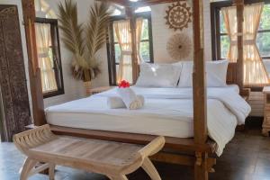 Postel nebo postele na pokoji v ubytování Bramasa Ubud Guest House