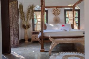 Postel nebo postele na pokoji v ubytování Bramasa Ubud Guest House