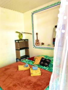 a bedroom with a bed with towels and a mirror at rent room papeete in Papeete