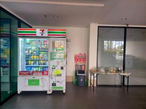 a store with a refrigerator and a table in a room at Vista Old Town Phuket in Ban Lo Long