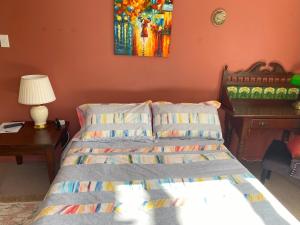 a bedroom with a bed and a table with a lamp at Limestone Studio in Whangarei