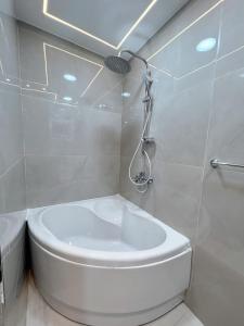 a white bathroom with a toilet and a shower at Comfy 3 Bedrooms Apartment in Cairo Sheraton Airport in Cairo +14 photos