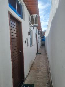 een steegje met een deur en een gebouw bij 05 Kitnet próximo da praia com ar-condicionado in Maceió