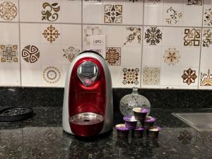 een rode mixer op een aanrecht met cupcakes bij 05 Kitnet próximo da praia com ar-condicionado in Maceió