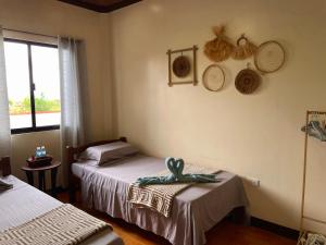 a room with two beds and baskets on the wall at The Shuim Dive Resort Moalboal in Moalboal