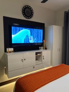 a living room with a television with a polar bear on the screen at Studio Condo in Saekyung Village One Phase3 in Lapu Lapu City