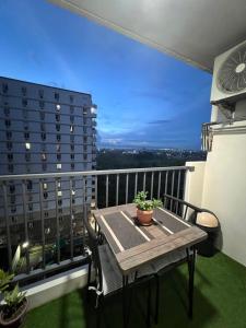 a balcony with a table and a view of a building at Studio Condo in Saekyung Village One Phase3 in Lapu Lapu City